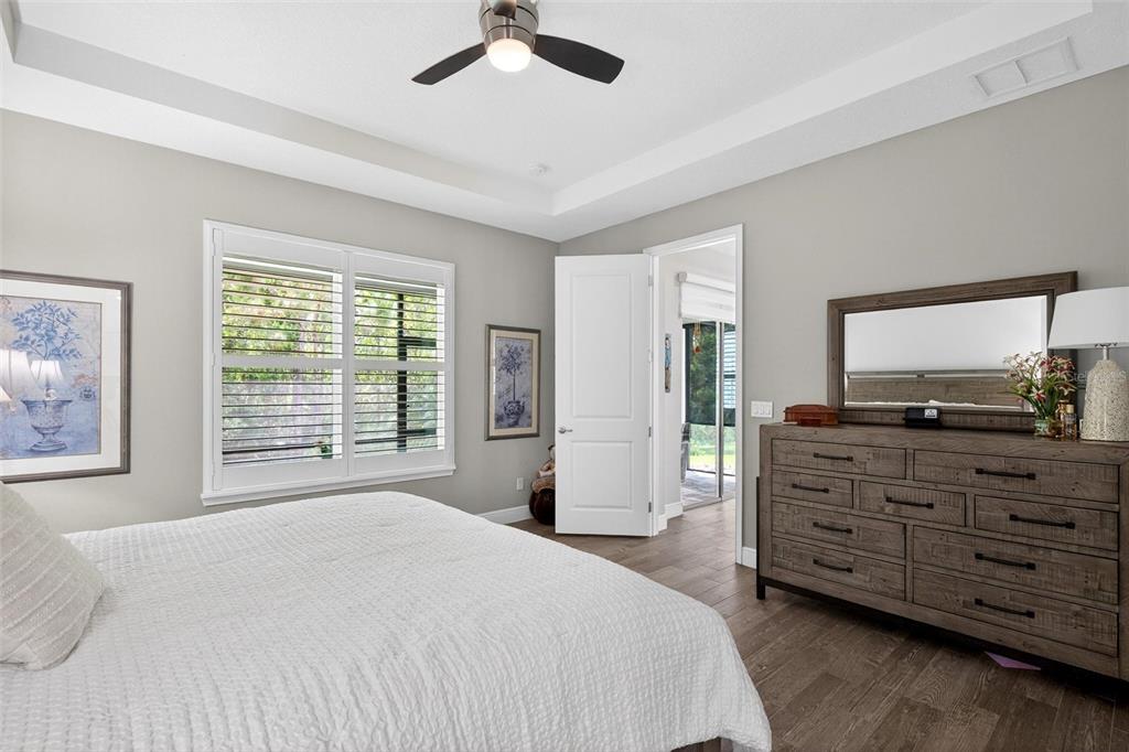 66 Wrendale Loop Ormond Beach, FL 32174 - Photo 22 of 88 a spacious bedroom with a large bed and a flat tv screen on dresser