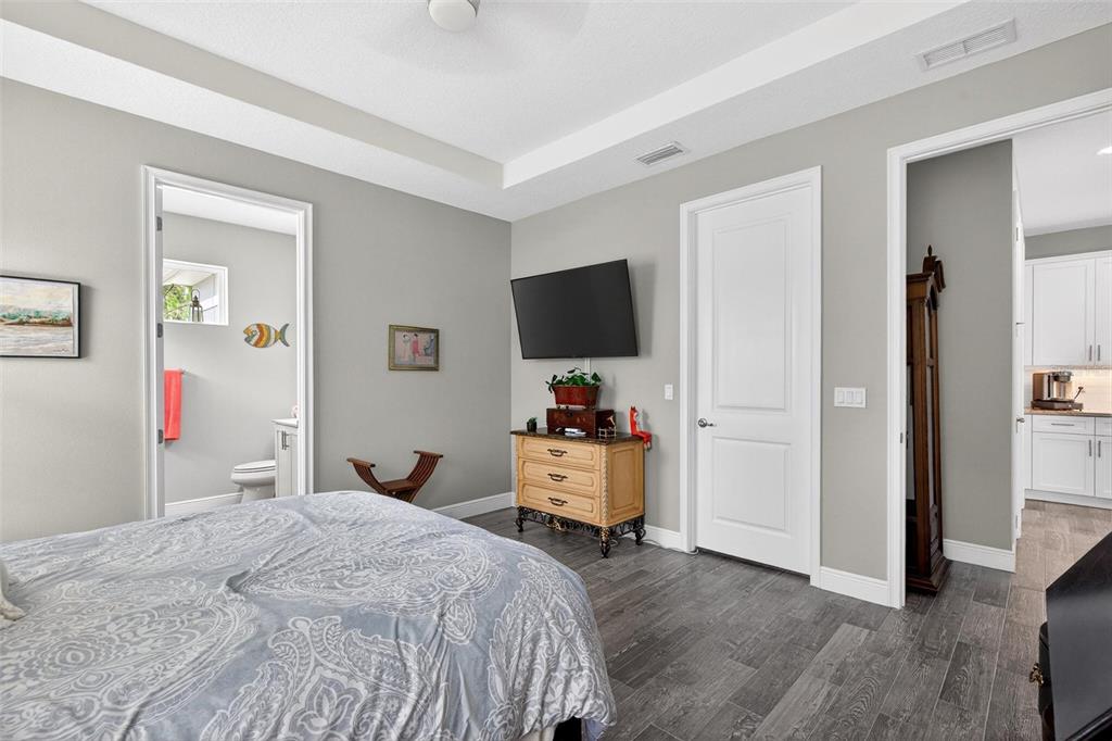 66 Wrendale Loop Ormond Beach, FL 32174 - Photo 29 of 88 a bedroom with a bed and a flat tv screen in it