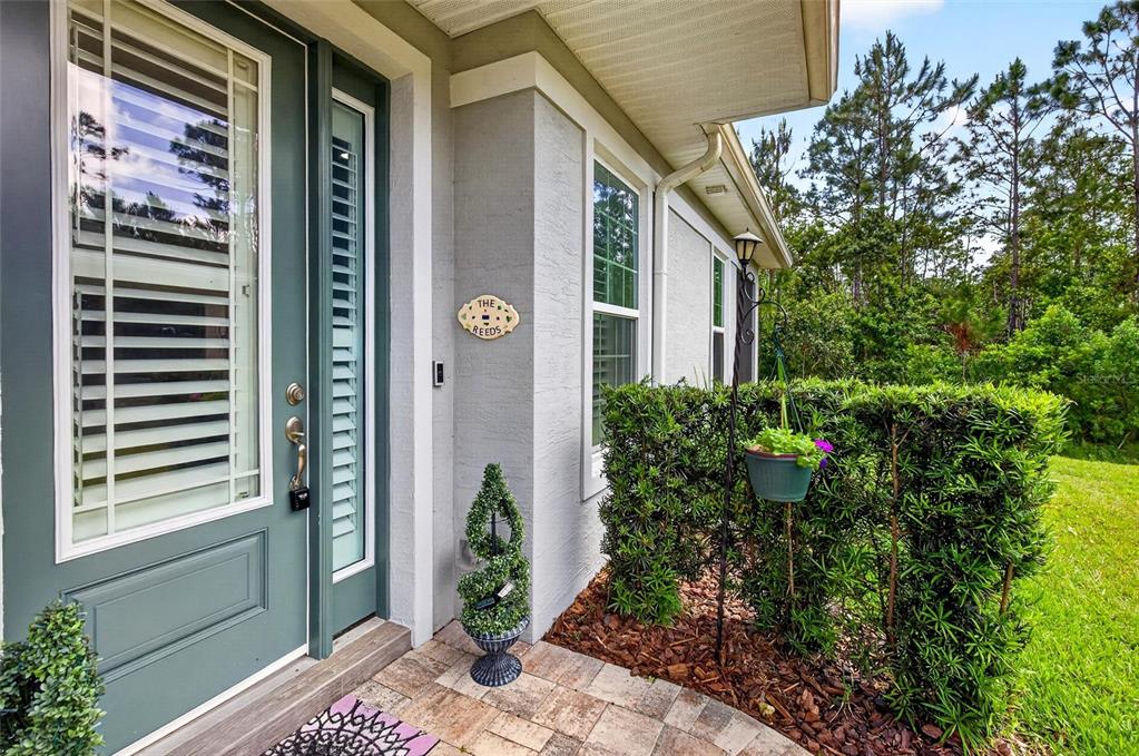 66 Wrendale Loop Ormond Beach, FL 32174 - Photo 3 of 88 a couple of potted plants in front of door