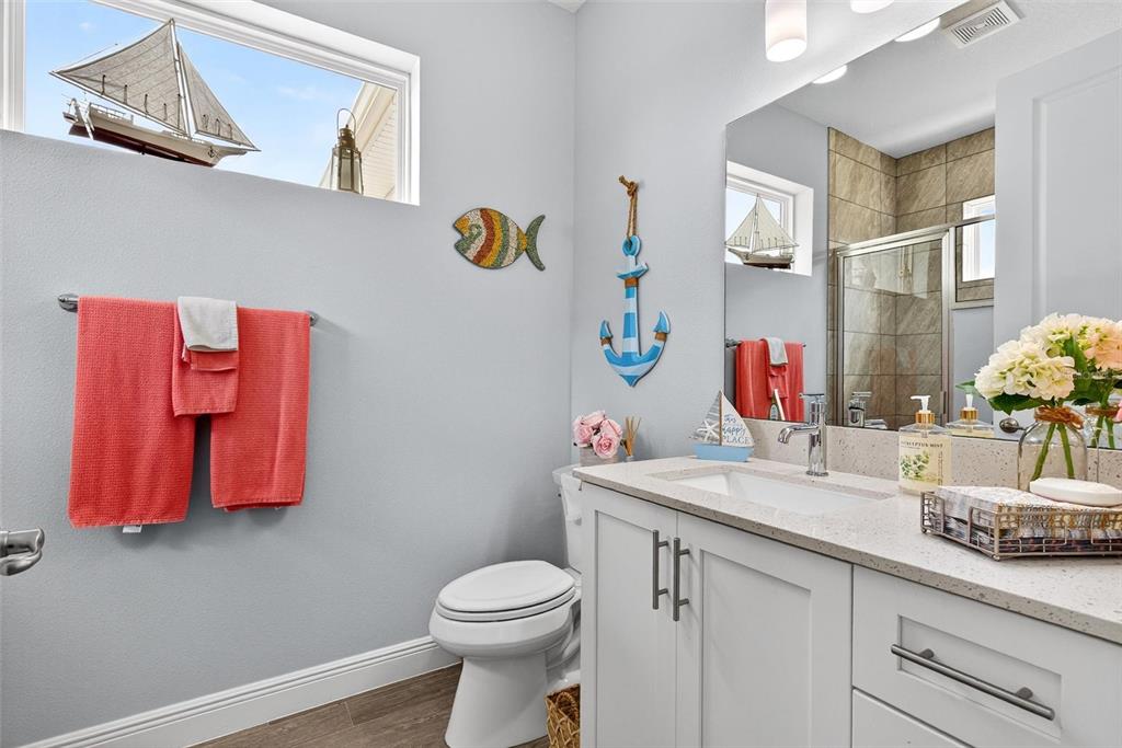 66 Wrendale Loop Ormond Beach, FL 32174 - Photo 32 of 88 a bathroom with a granite countertop sink a toilet and a mirror