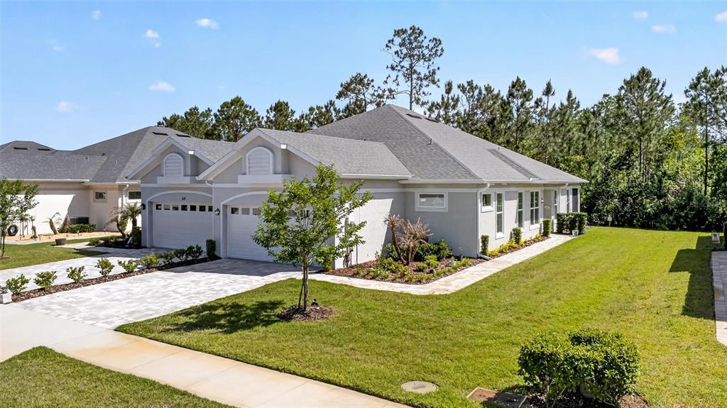 66 Wrendale Loop Ormond Beach, FL 32174 - Photo 49 of 88 a aerial view of a house with swimming pool and a yard