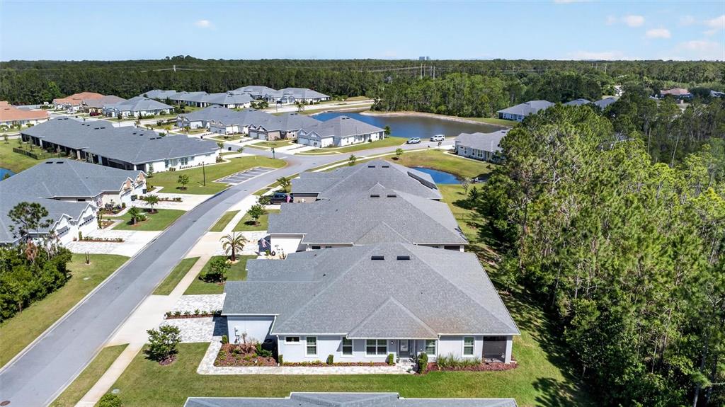 66 Wrendale Loop Ormond Beach, FL 32174 - Photo 53 of 88 an aerial view of residential houses with outdoor space and trees