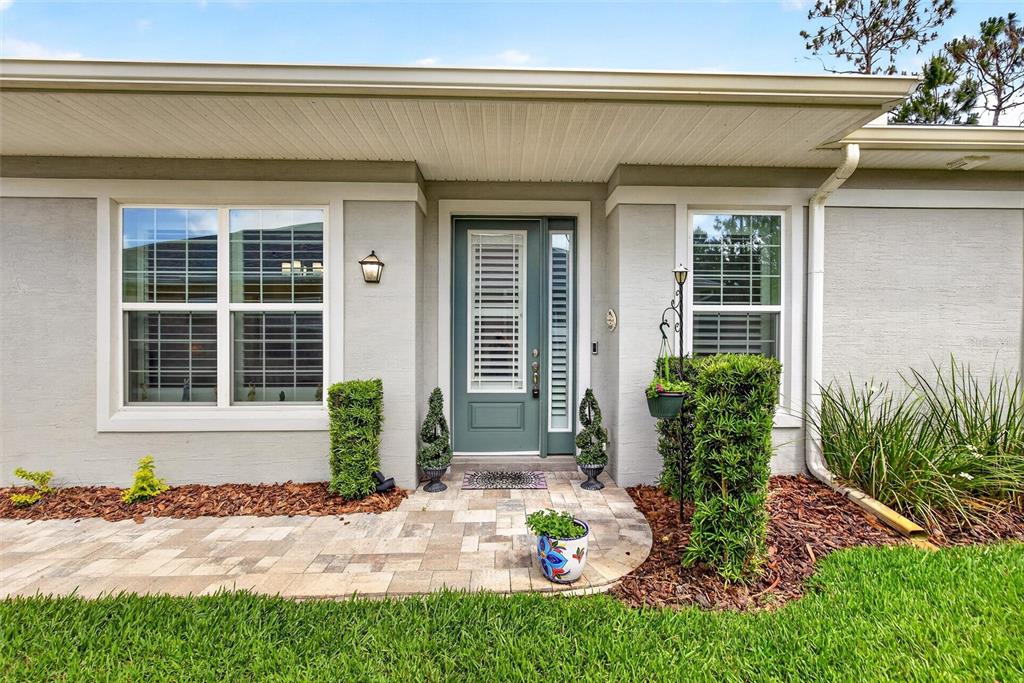 66 Wrendale Loop Ormond Beach, FL 32174 - Photo 62 of 88 a front view of a house with a yard and plants