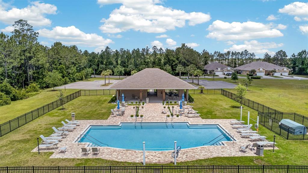 66 Wrendale Loop Ormond Beach, FL 32174 - Photo 72 of 88 a view of a swimming pool with a patio