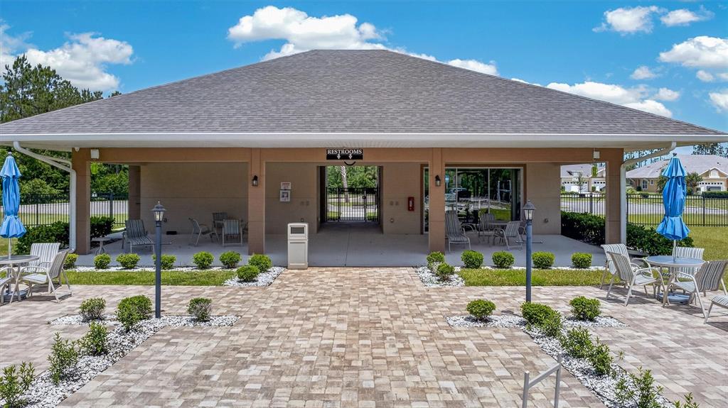 66 Wrendale Loop Ormond Beach, FL 32174 - Photo 74 of 88 a view of a house with backyard sitting area and garden