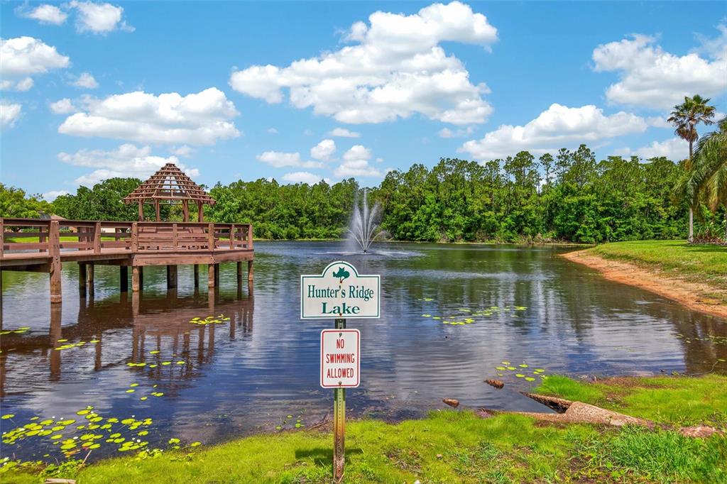 66 Wrendale Loop Ormond Beach, FL 32174 - Photo 81 of 88 a view of a lake with a yard