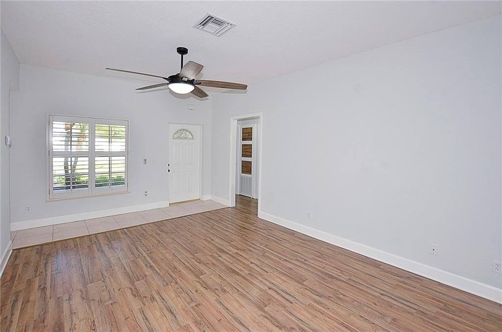 3285 3rd Place Vero Beach, FL 32968 - Photo 11 of 34 wooden floor in an empty room with a window