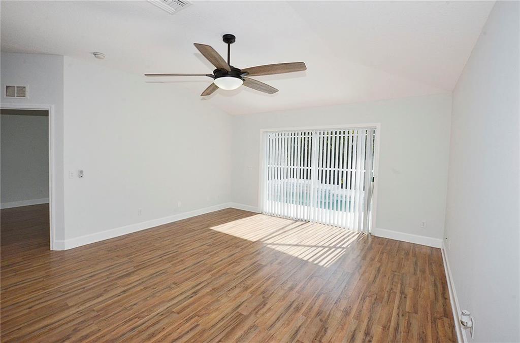 3285 3rd Place Vero Beach, FL 32968 - Photo 15 of 34 a view of empty room with wooden floor and fan