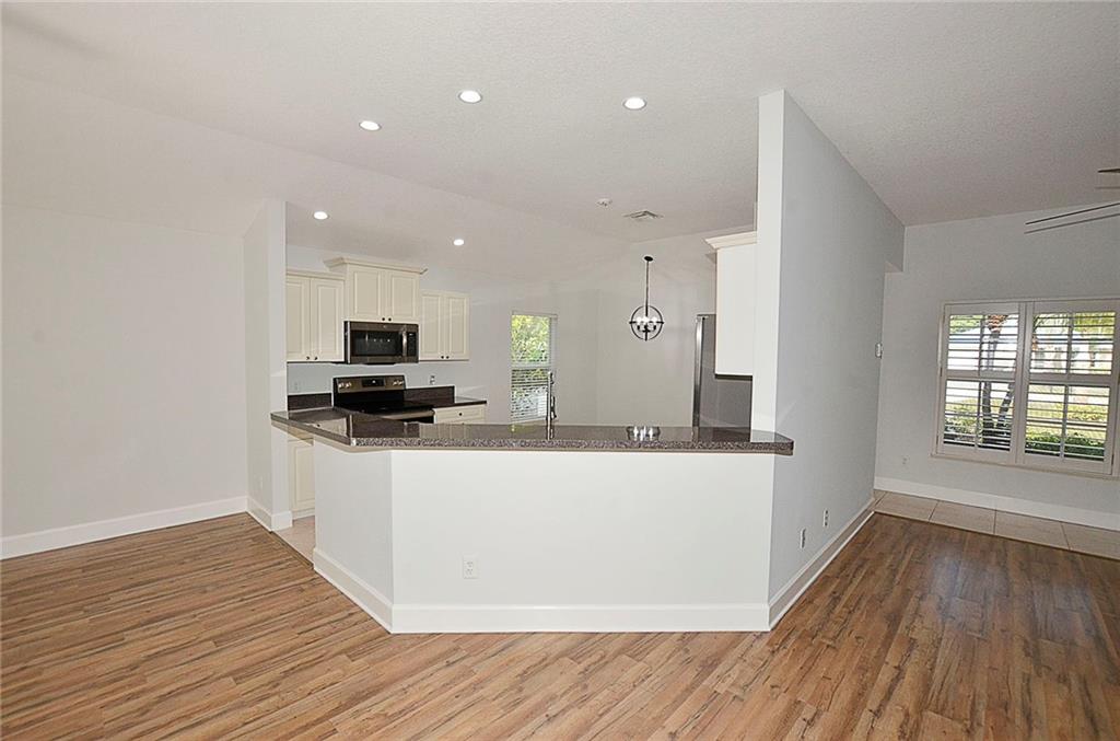 3285 3rd Place Vero Beach, FL 32968 - Photo 17 of 34 a living room with stainless steel appliances kitchen island wooden floors and view living room