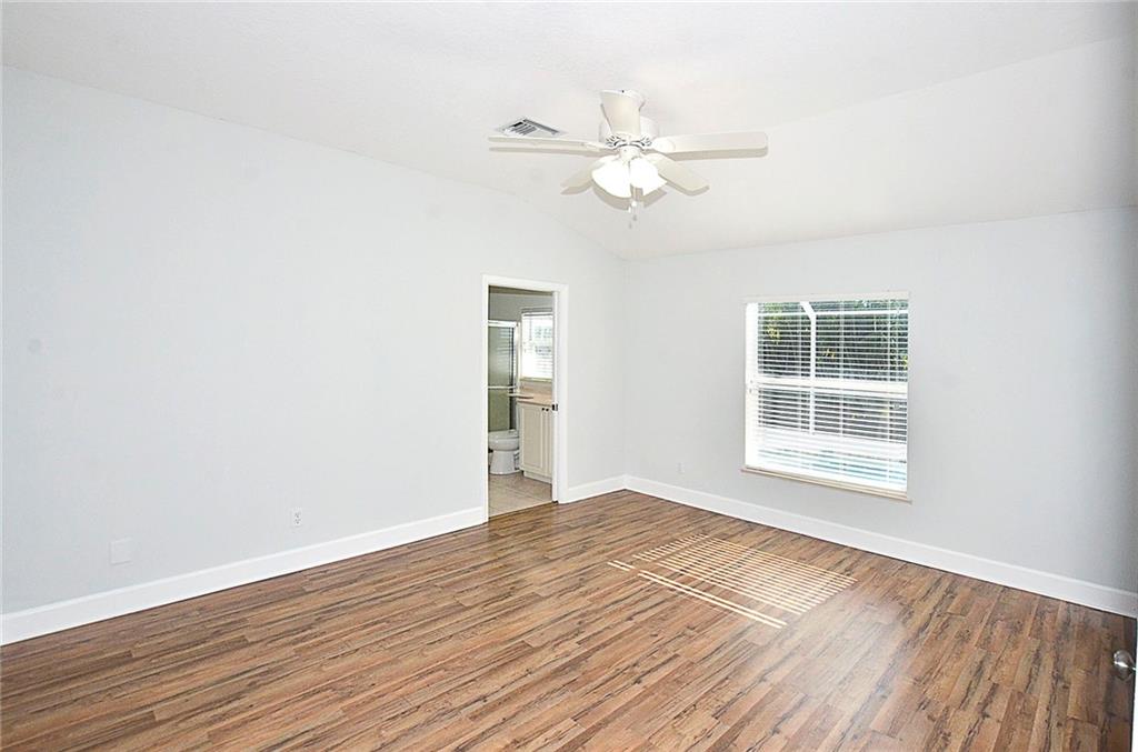 3285 3rd Place Vero Beach, FL 32968 - Photo 19 of 34 a view of empty room with wooden floor and fan