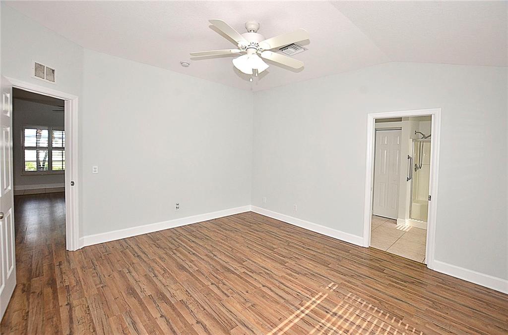 3285 3rd Place Vero Beach, FL 32968 - Photo 20 of 34 wooden floor in an empty room with a window