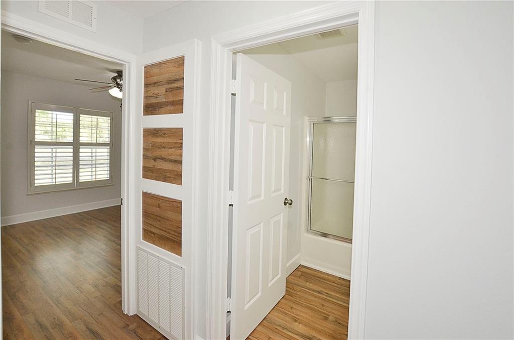 3285 3rd Place Vero Beach, FL 32968 - Photo 24 of 34 a view of a hallway with wooden floor and a bathroom