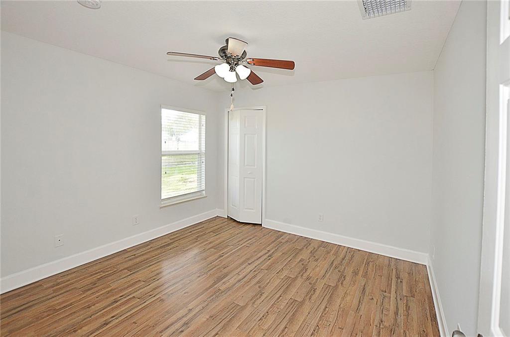 3285 3rd Place Vero Beach, FL 32968 - Photo 25 of 34 a view of an empty room with wooden floor and a window