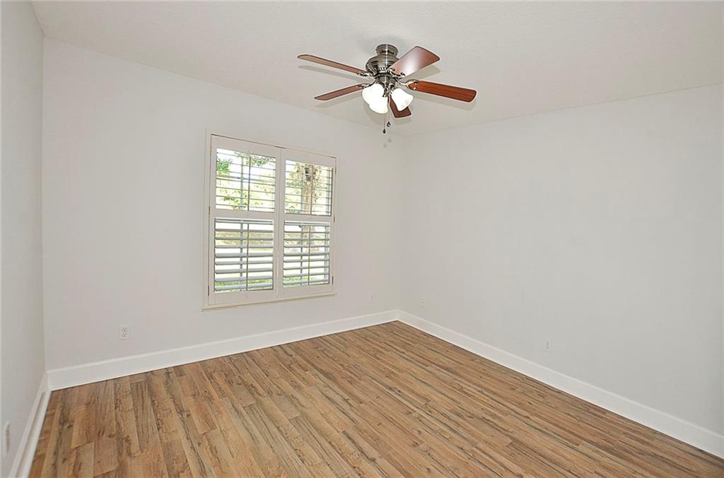 3285 3rd Place Vero Beach, FL 32968 - Photo 27 of 34 a view of an empty room with wooden floor and a window