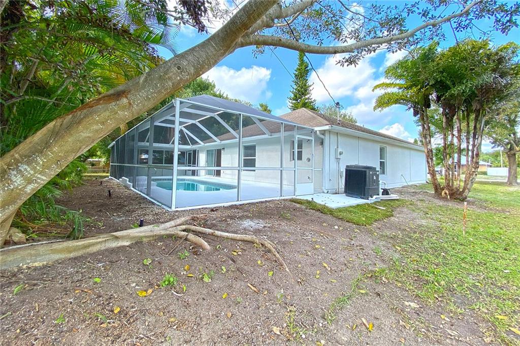 3285 3rd Place Vero Beach, FL 32968 - Photo 31 of 34 a view of a house with a yard and large trees