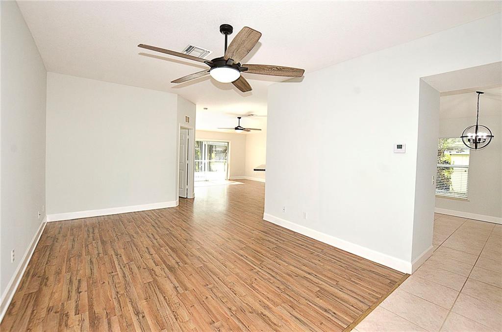 3285 3rd Place Vero Beach, FL 32968 - Photo 10 of 34 an empty room with wooden floor a ceiling fan and closet