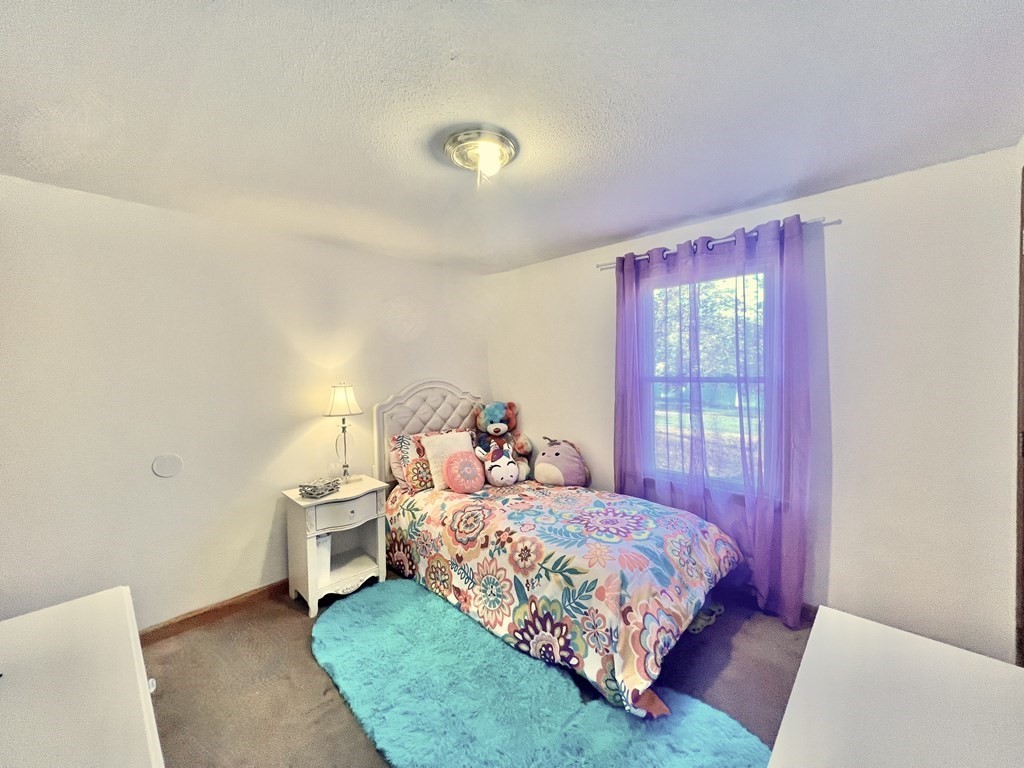 140 Ellendale Circle Springfield, MA 01128 - Photo 14 of 21 a bedroom with a bed and a chandelier