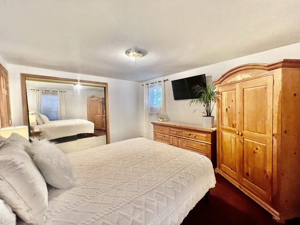140 Ellendale Circle Springfield, MA 01128 - Photo 10 of 21 a bedroom with a bed and a flat screen tv