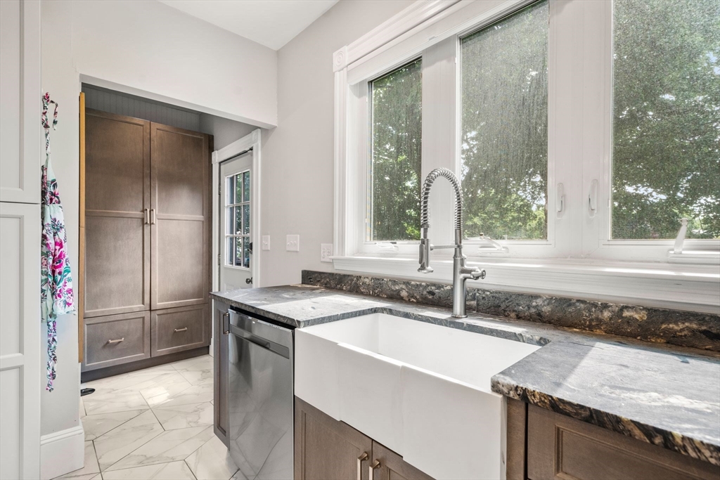 18 Mill Street Boston, MA 02122 - Photo 11 of 38 a kitchen with a sink stove and refrigerator