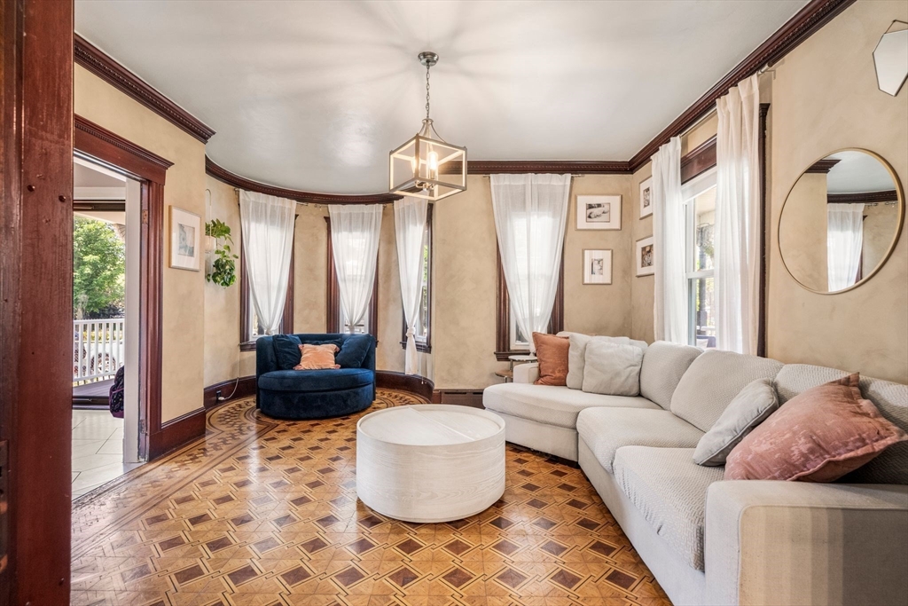 18 Mill Street Boston, MA 02122 - Photo 13 of 38 a living room with furniture and a large window