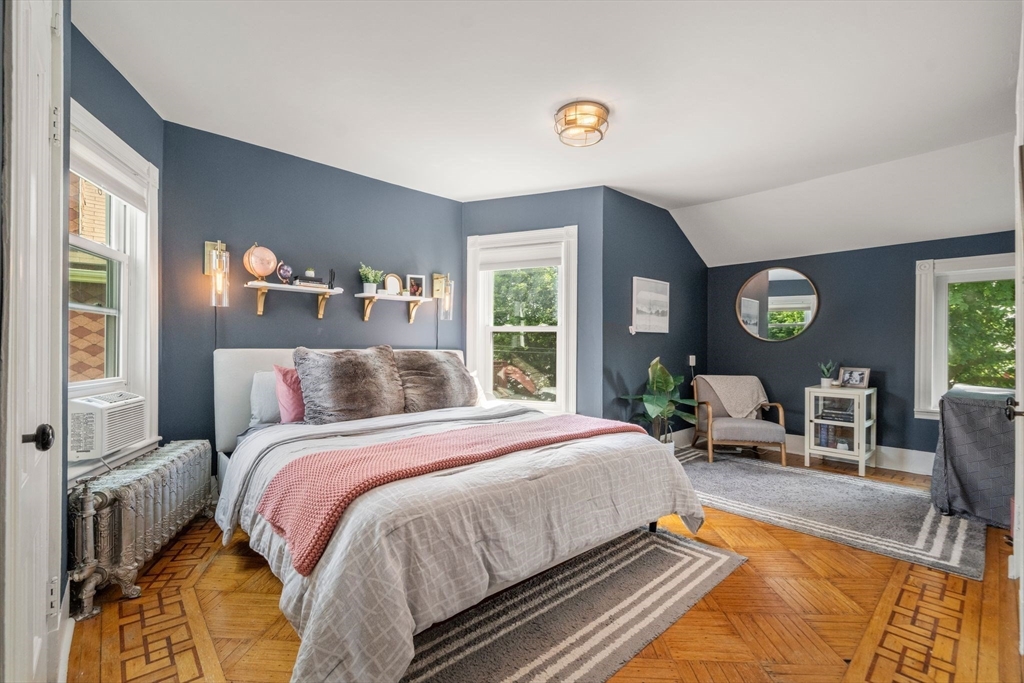 18 Mill Street Boston, MA 02122 - Photo 16 of 38 a bed sitting in a bedroom next to a window