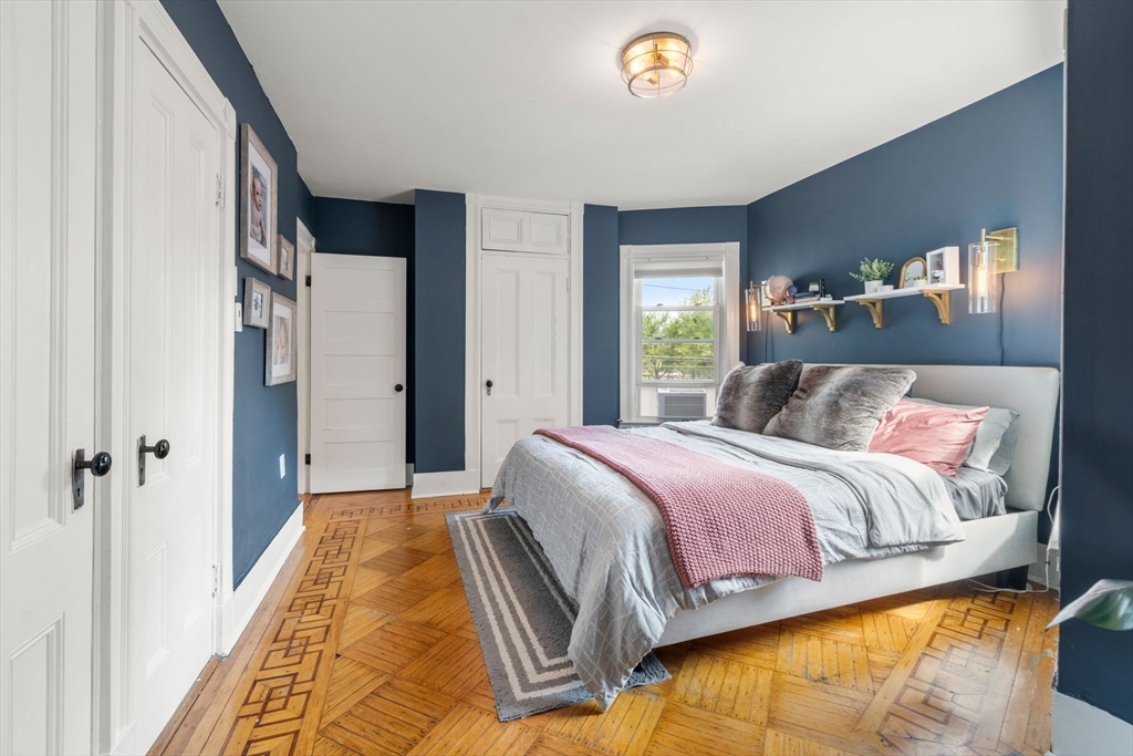 18 Mill Street Boston, MA 02122 - Photo 17 of 38 a bedroom with a bed and a window