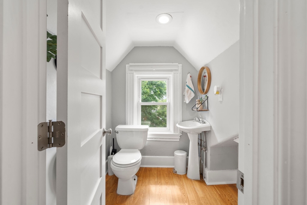 18 Mill Street Boston, MA 02122 - Photo 29 of 38 a white toilet sitting next to a window and a shower