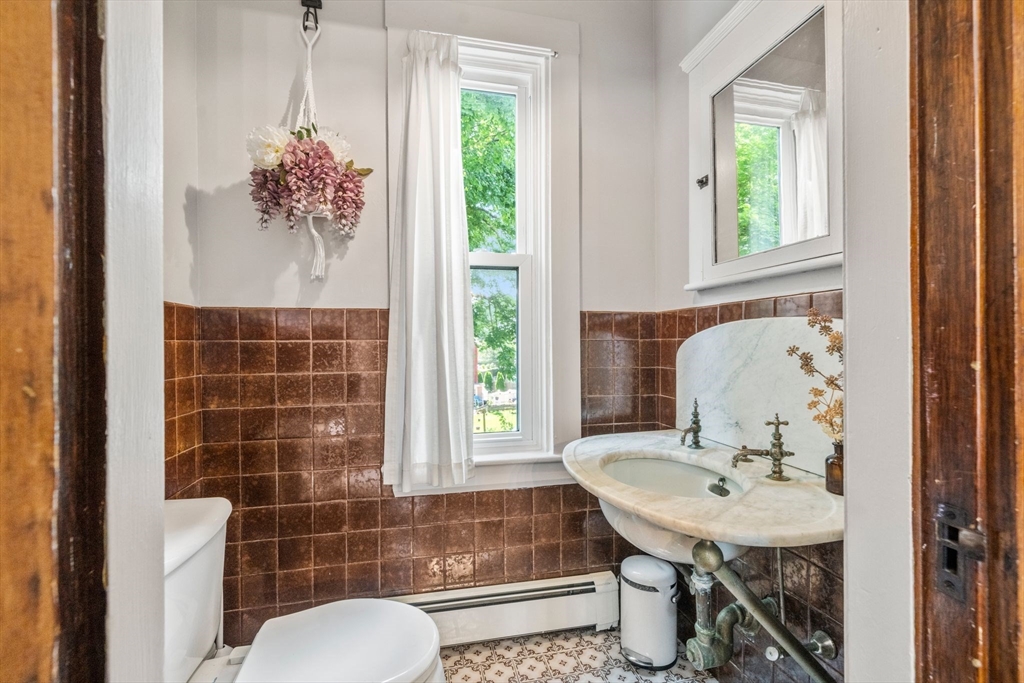 18 Mill Street Boston, MA 02122 - Photo 30 of 38 a bathroom with a sink toilet and shower