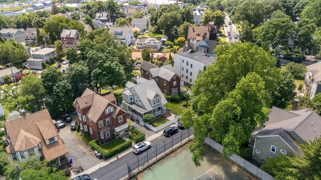 18 Mill Street Boston, MA 02122 - Photo 3 of 38 an aerial view of a house with a yard and trees