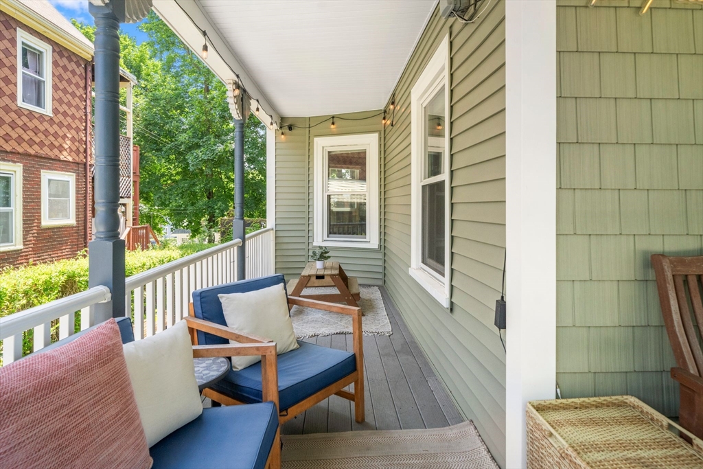 18 Mill Street Boston, MA 02122 - Photo 31 of 38 a balcony with wooden floor and furniture
