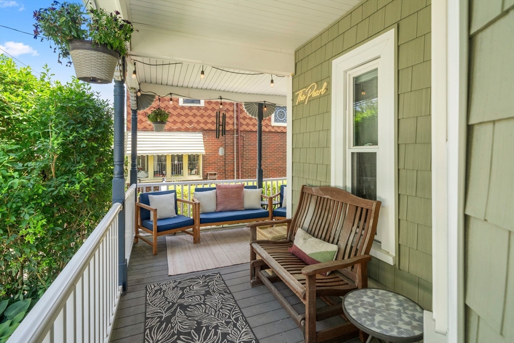 18 Mill Street Boston, MA 02122 - Photo 32 of 38 a living room with patio furniture and a floor to ceiling window