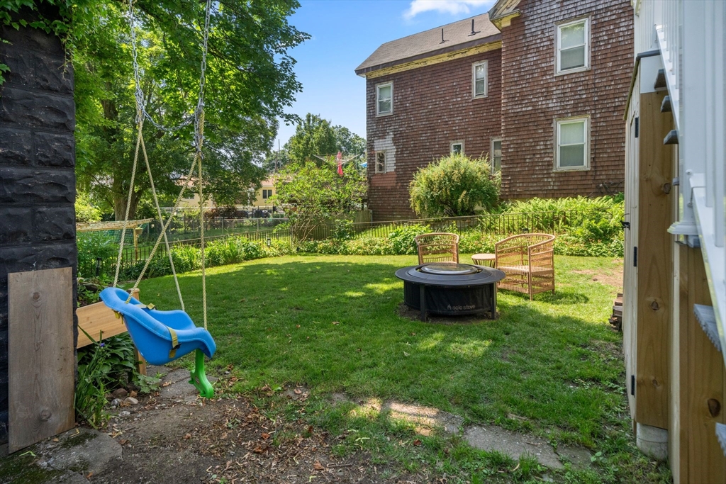 18 Mill Street Boston, MA 02122 - Photo 34 of 38 a view of a backyard with table and chairs and potted plants