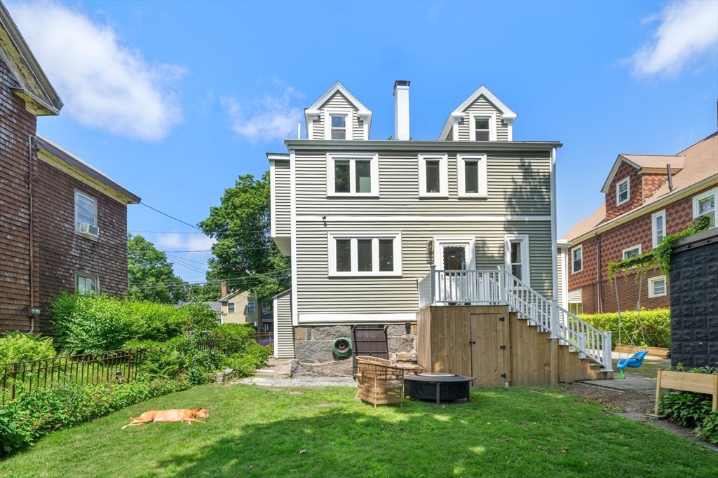18 Mill Street Boston, MA 02122 - Photo 35 of 38 a front view of a house with a garden and sitting area