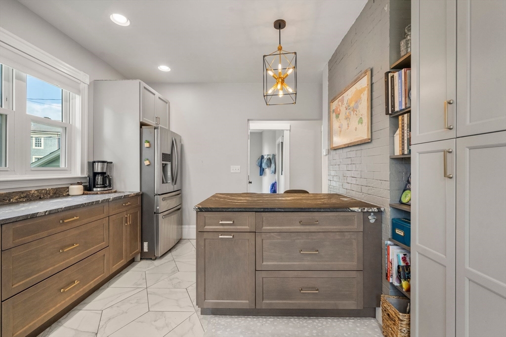 18 Mill Street Boston, MA 02122 - Photo 8 of 38 a kitchen with stainless steel appliances granite countertop a refrigerator and a stove