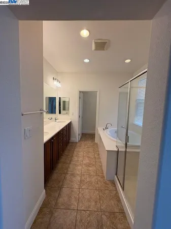 a large bathroom with a sink a toilet and shower