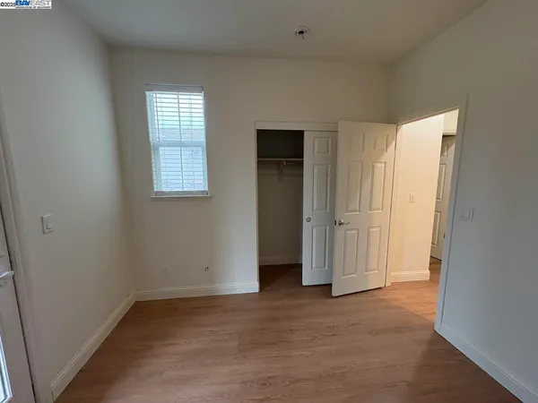 an empty room with windows and closet