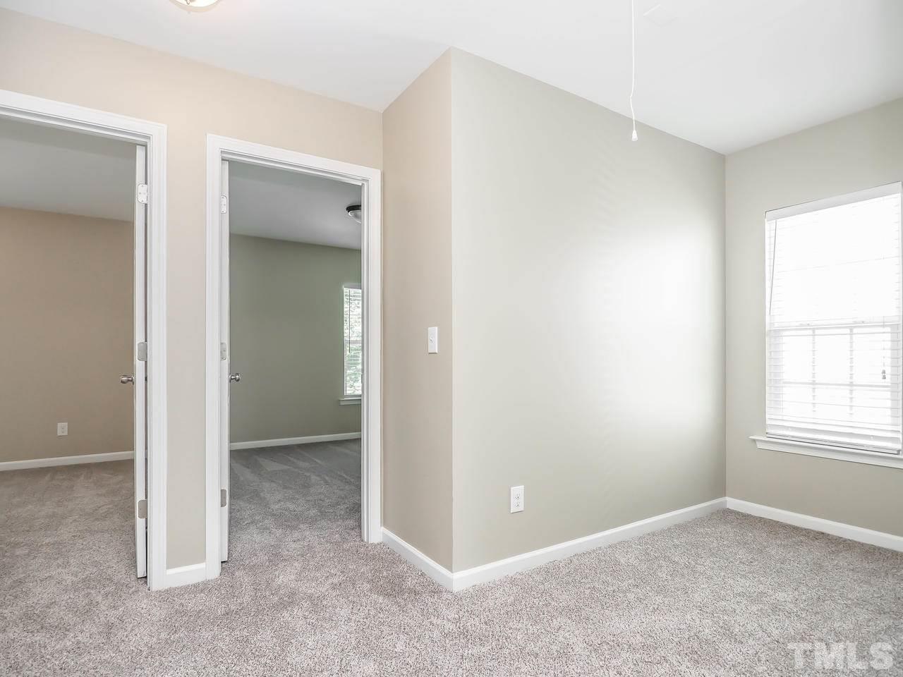 934 Ileagnes Road Raleigh, NC 27603 - Photo 12 of 23 an empty room with windows and closet