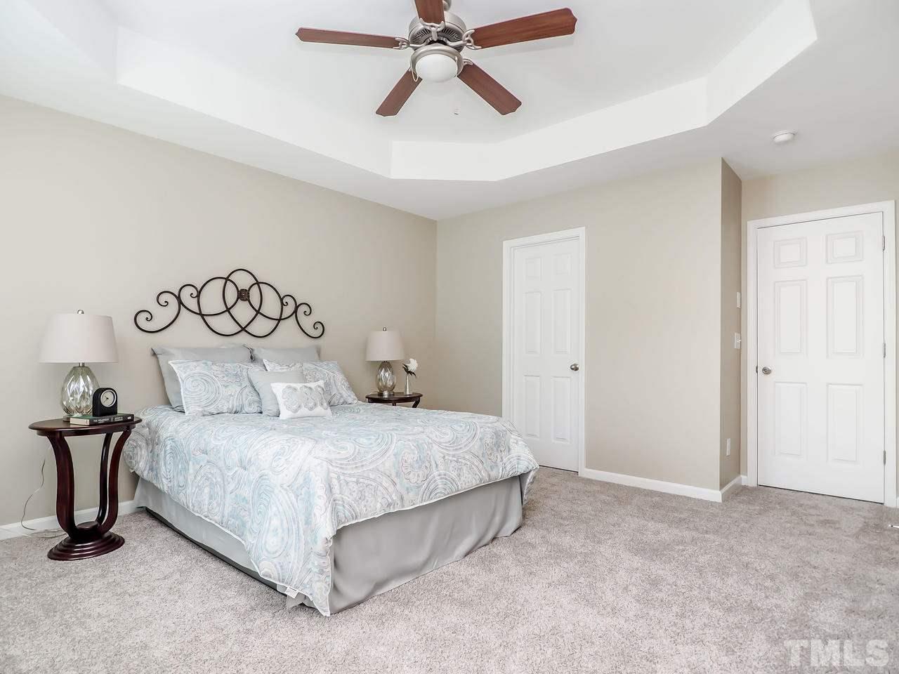 934 Ileagnes Road Raleigh, NC 27603 - Photo 16 of 23 a bedroom with a bed and painting on the wall