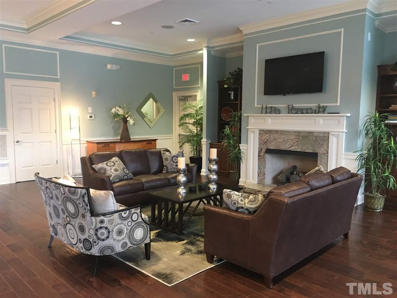 934 Ileagnes Road Raleigh, NC 27603 - Photo 22 of 23 a living room with furniture a flat screen tv and a fireplace