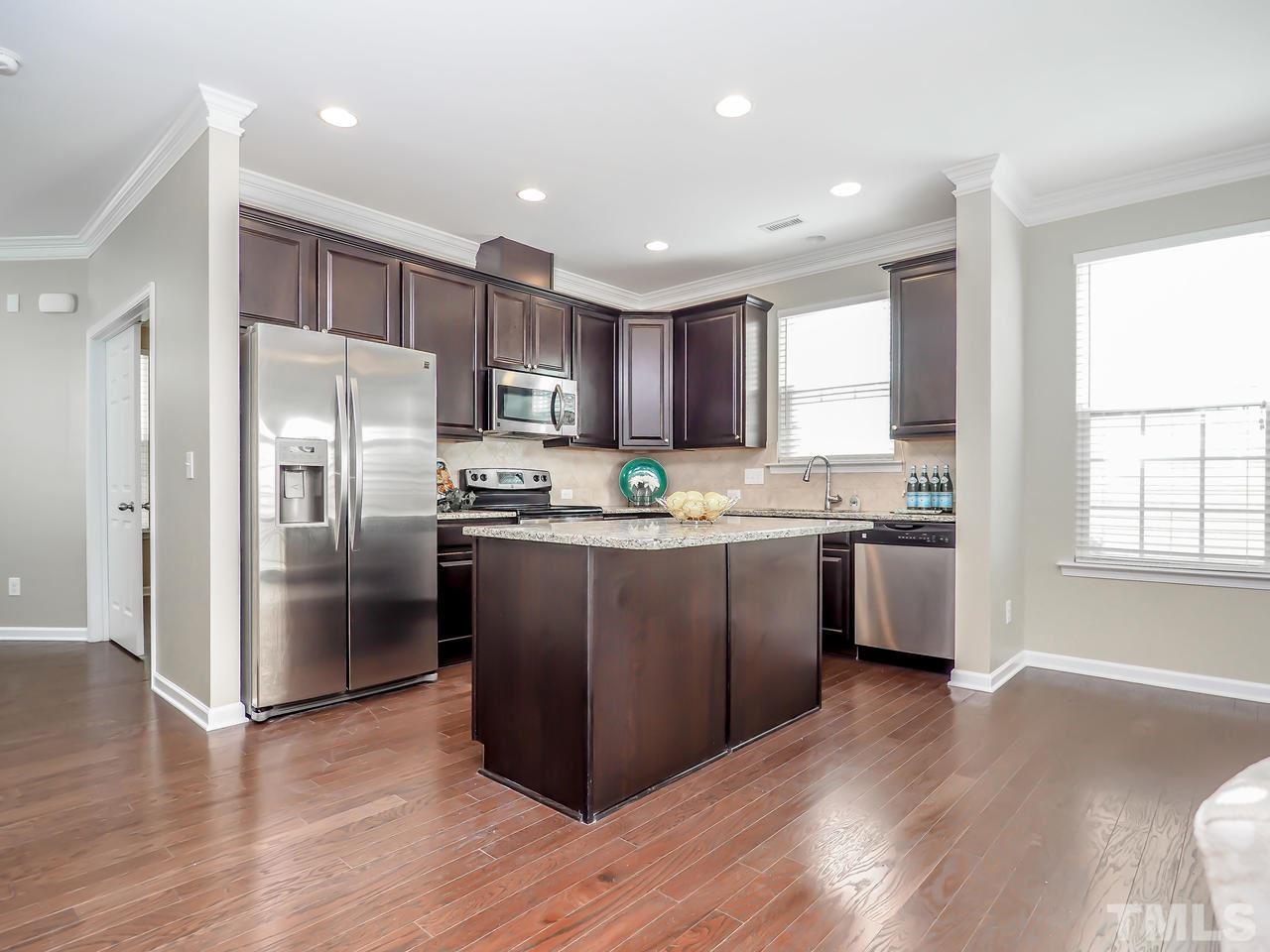 934 Ileagnes Road Raleigh, NC 27603 - Photo 6 of 23 a kitchen with a refrigerator a sink and a stove top oven