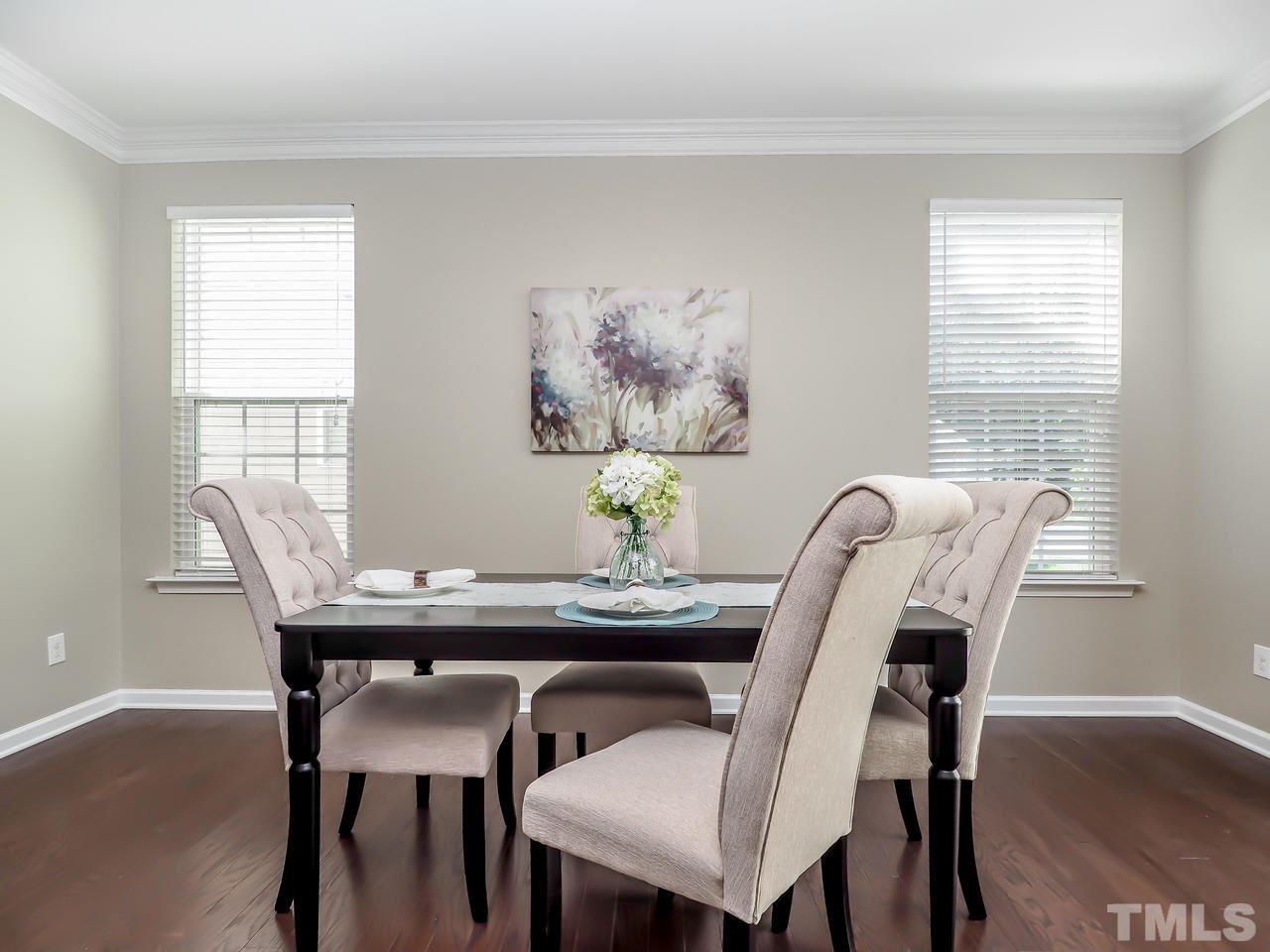 934 Ileagnes Road Raleigh, NC 27603 - Photo 9 of 23 a view of a dining room with furniture and wooden floor