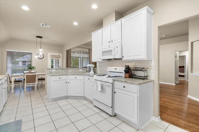 a kitchen with appliances cabinets and a sink