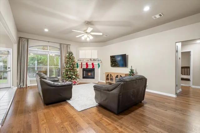 a living room with furniture a flat screen tv and a fireplace