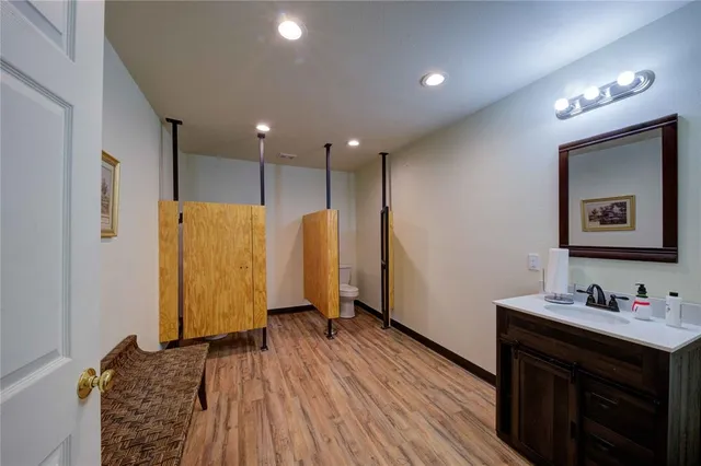 a spacious bathroom with a sink a mirror and a shower