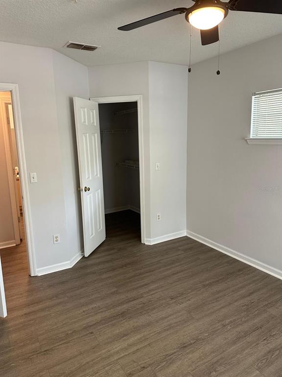 4352 South Kirkman Road, Unit 1204 Orlando, FL 32811 - Photo 18 of 23 a view of an empty room with wooden floor and closet