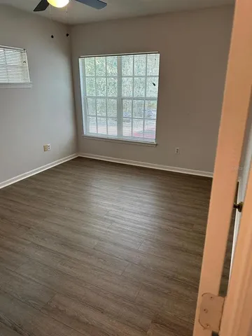 a view of a room with wooden floor