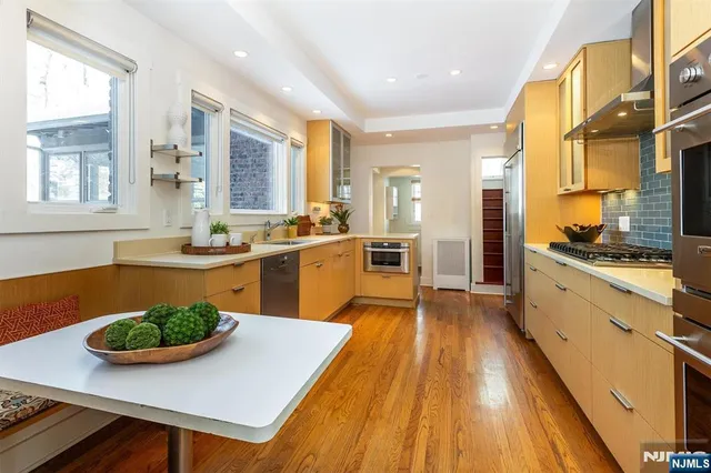 a large kitchen with kitchen island a large window