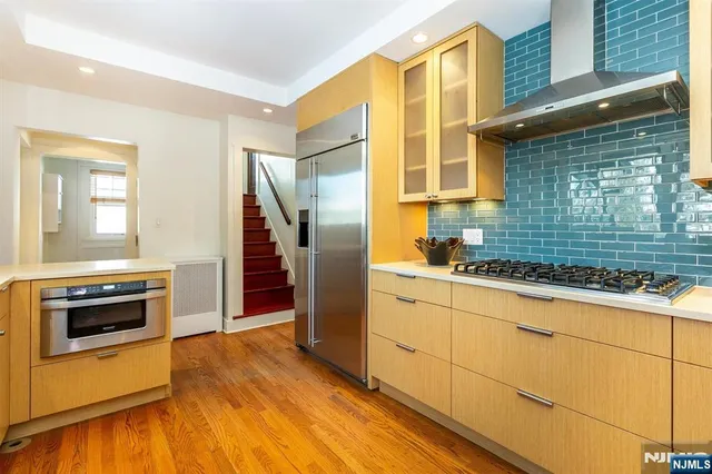 a kitchen with granite countertop a refrigerator and a stove