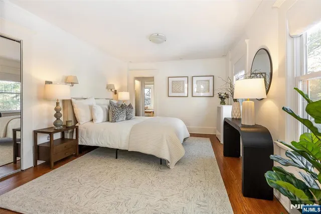 a bedroom with bed and wooden floor