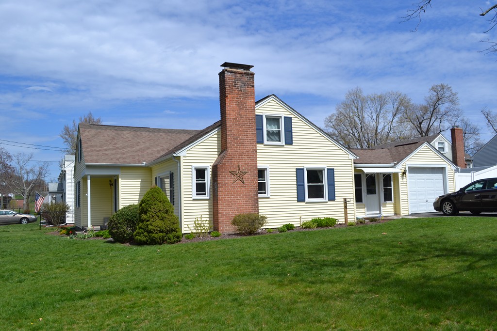 103 Pilgrim Road Springfield, MA 01118 - Photo 3 of 26 a front view of a house with a yard and garage